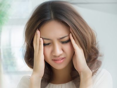 sick stressed dizzy woman suffering from vertigo, dizziness, headache GoPatch natural relief from vertigo